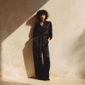 Black tie-waist silk trousers, mulberry silk by Jhouni — editorial photography, soft natural light, model wearing the piece