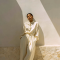 Ivory pleated silk trousers, mulberry silk by Jhouni — editorial photography, soft natural light, model wearing the piece